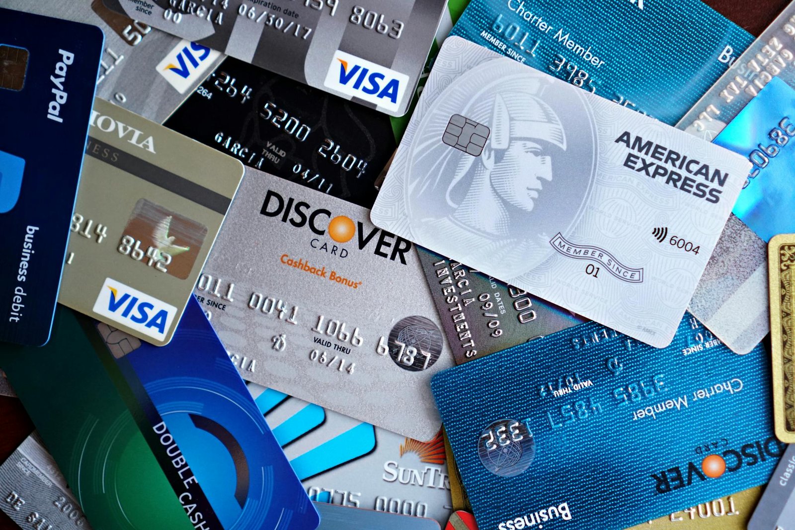 FAQ 2 Close-up image of various credit cards including Visa, Mastercard, and American Express.