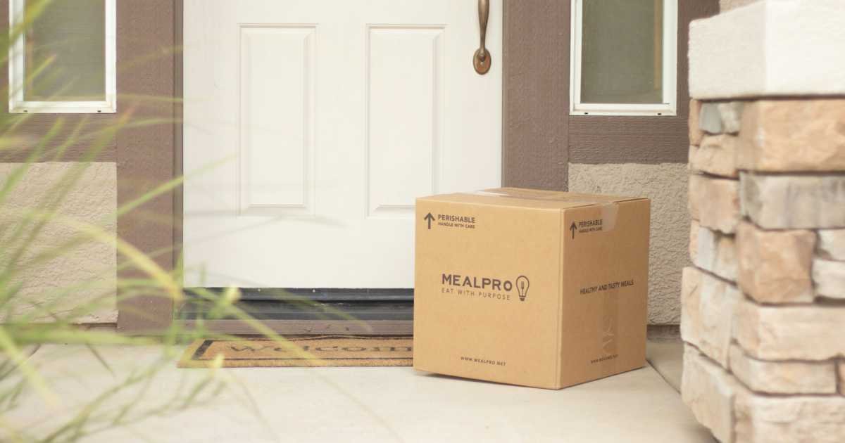 Cardboard delivery parcel by a front door illustrating package protection