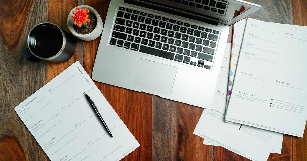Laptop and financial papers used to review a credit reporting membership
